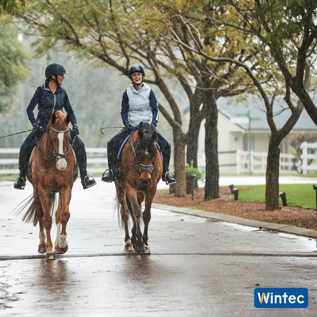 Two riders hacking out in the rain on Wintec saddles