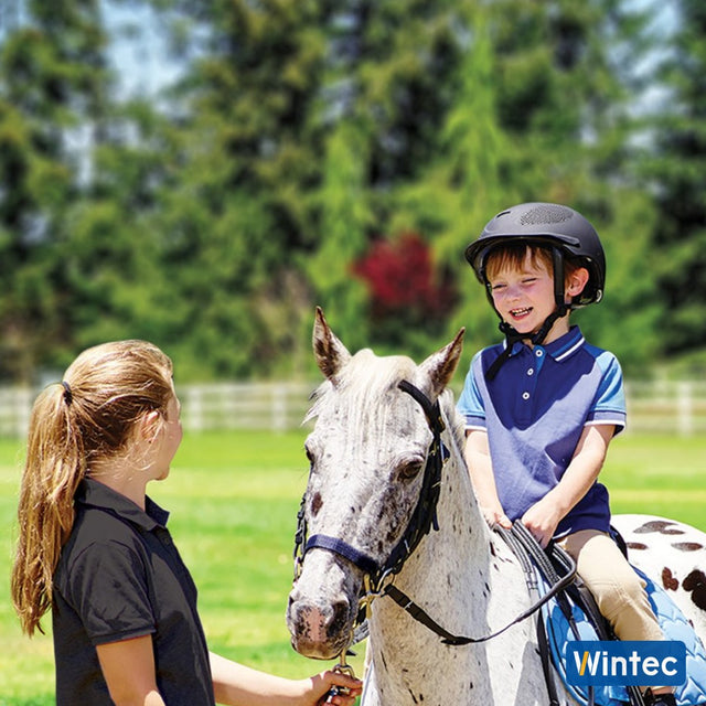 Young boy on a spotted pony with the Wintec Kids Saddle Pack