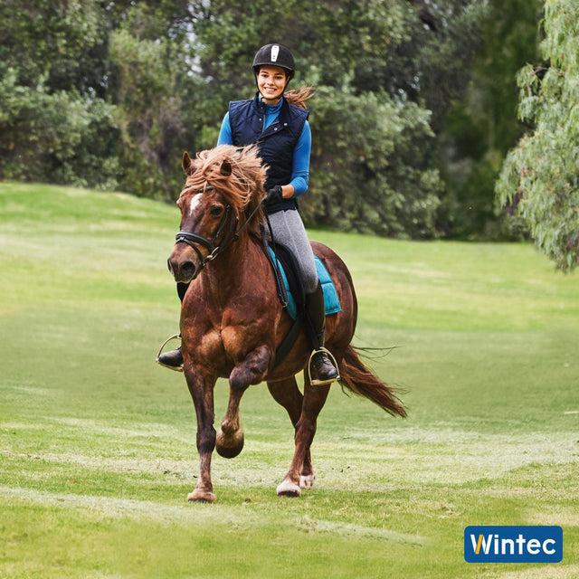 Young rider cantering a pony in a Wintec saddle